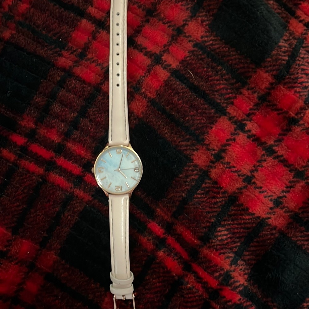 Tan watch with gold around it it is fully functional